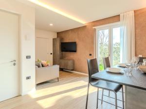 a dining room and living room with a table and chairs at Apartment Garda Oasis by Interhome in Riva del Garda