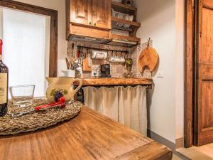 a kitchen with a wooden counter top with a bottle of wine at Apartment Cia by Interhome in Palazzuolo sul Senio