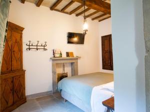 a bedroom with a bed and a fireplace at Apartment Cia by Interhome in Palazzuolo sul Senio