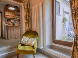 a yellow chair in a room with a window at Apartment Cia by Interhome in Palazzuolo sul Senio
