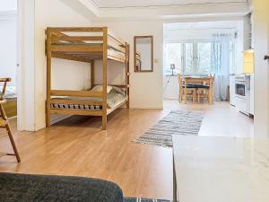 a living room with two bunk beds and a table at Apartment Stadsro by Interhome in Vimmerby