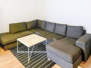 a living room with a couch and a coffee table at Apartment Stadsro by Interhome in Vimmerby