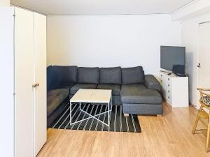 a living room with a couch and a table at Apartment Stadsro by Interhome in Vimmerby