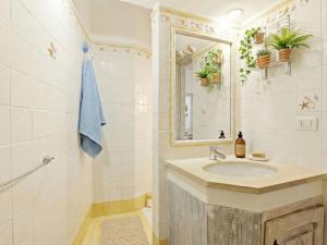 a bathroom with a sink and a mirror at Apartment Vista 9 by Interhome in Porto Cervo