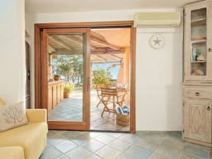 a living room with a door open to a patio at Apartment Vista 9 by Interhome in Porto Cervo