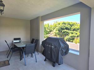 a dining room with a table and a window at Miskin Place Unit 2 in Kelso