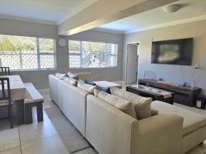 a living room with a large couch and a table at Miskin Place Unit 2 in Kelso