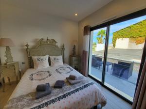 a bedroom with a bed and a large glass window at Les Cuves - Saintes - Chambres d'hôtes et gîte in Saintes +41 photos