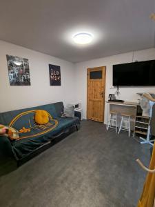 a living room with a couch and a desk at Flores Apartament in Katowice