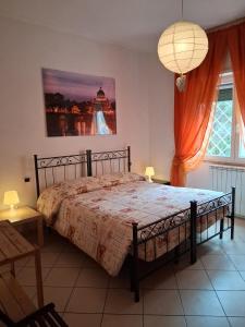 a bedroom with a bed and a large window at B&B Salviani in Acilia