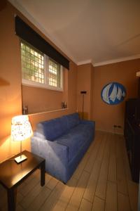 ローマにあるBed&BikeRome Suiteのリビングルーム(青いソファ、テーブル付)