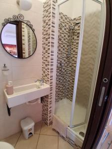 a bathroom with a shower and a sink at B&B Salviani in Acilia