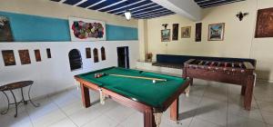 a room with a pool table and a piano at Pousada Hotel Casarão SerraNegra in Serra Negra