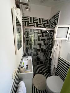 a bathroom with a black and white patterned wall at Villa Croce Anacapri in Anacapri +32 photos