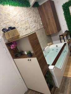 a bathroom with a bath tub in a kitchen at SpaNish SKY 1 sauna&jacuzzi in Niš +29 photos