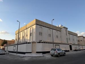 a car parked in front of a building at TwentyFour Seven Residence in Tabuk