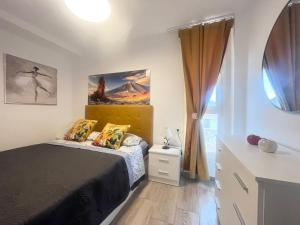 a bedroom with a bed and a window at playa honda sky view in Playa de las Americas +10 photos