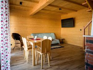 a room with a table and chairs and a couch at Ostoja Urnica in Falsztyn