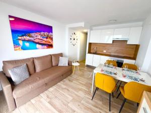 a living room and kitchen with a couch and a table at playa honda sky view in Playa de las Americas