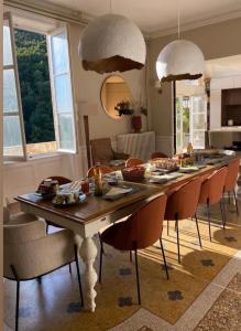 a dining room with a table and chairs with food on it at La Romanee d Or in Marchampt