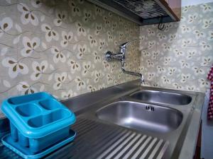 a stainless steel sink with a faucet at Apartment Su Cramu in Villacidro +57 photos