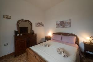 a bedroom with a bed with two towels on it at Apartment Su Cramu in Villacidro