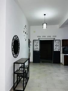 a room with a table and a door and a table and chairs at L'Appart des Amis in Antsiranana