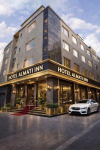 a hotel with a car parked in front of it at Hotel Almati Inn Near IGI Delhi Airport - With Free Airport Pickup in New Delhi