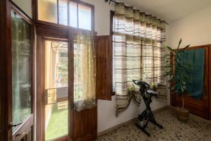 a room with a window and a scooter in front of it at Apartment Su Cramu in Villacidro