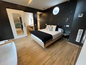 a bedroom with a large bed with a moon on the wall at Casal de pelaio in Barreiros