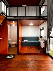 a room with a bed and a toilet in a room at Krincing Hills Cabin in Kalijoso
