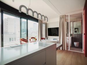 a bathroom with a large window with a view of a city at Scarlet Jacuzzi Suit by Sofija in Warsaw