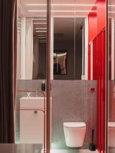 a bathroom with a toilet and a sink at Scarlet Jacuzzi Suit by Sofija in Warsaw +27 photos