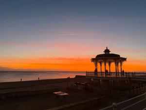 a gazebo on the beach at sunset at The Brighton Hotel Seafront in Brighton & Hove