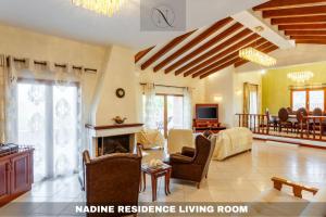 a large living room with a fireplace and a living room at Epavlis Nadine Corfu in Corfu