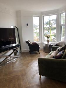 a living room with two couches and a flat screen tv at harbourways in Looe