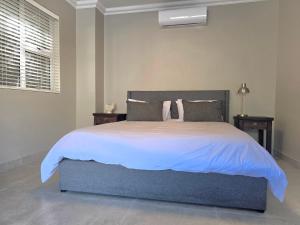 a bedroom with a large bed with white sheets and pillows at Miskin Place Unit 3 in Pennington +35 photos