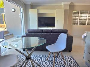 a living room with a glass table and a couch at Miskin Place Unit 3 in Pennington