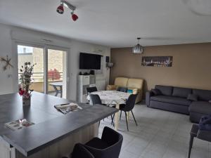 a living room with a couch and a table at domette in Grandcamp-Maisy