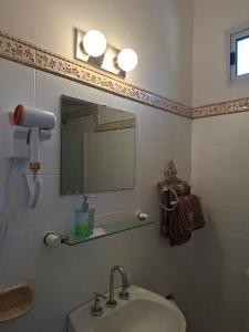 a bathroom with a sink and a mirror at VersionMoreno apart hotel in General Villegas +16 photos