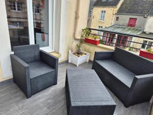 two chairs and a table on a balcony at domette in Grandcamp-Maisy