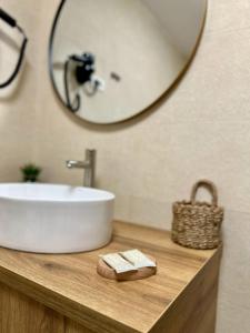 a bathroom with a sink and a mirror at Casa Sima 2 in Curtea de Argeş