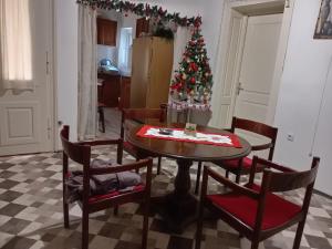 a living room with a table and a christmas tree at Vila Alex in Vrnjačka Banja
