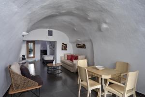 a living room with a couch and a table at Aroma Suites in Fira