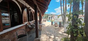 a building with a stone walkway with chairs on it at Pousada Hotel Casarão SerraNegra in Serra Negra