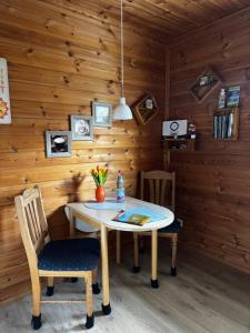 a wooden room with a table and a chair at Ferienwohnung“puutalossa“ in Sehlen +14 photos