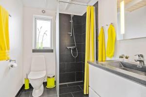 a bathroom with a toilet and a sink and a shower at K19082-Kalundborg-Sandlodsvej-18 in Asnæs +23 photos