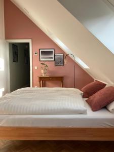 a bedroom with a white bed and a staircase at freiheitACHT in Raesfeld