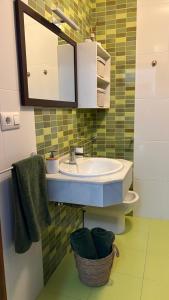 a bathroom with a sink and a mirror at Apartamento Altamar Portonovo, 100 m playa in Sanxenxo +4 photos