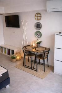 a table and chairs in a living room with a tv at Abby Apartment Koper in Koper +1 photo